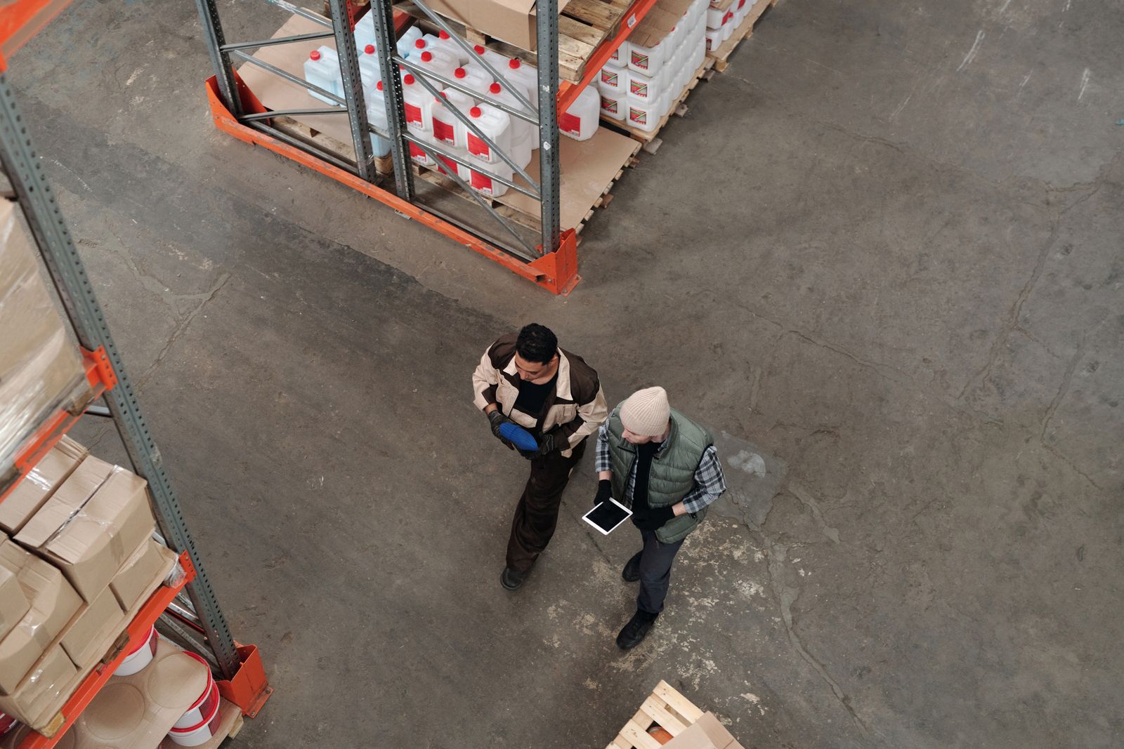 Warehouse team in Fargo reviewing inventory on a tablet connected to automated workflows